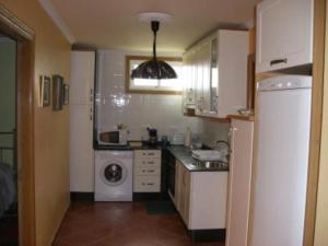 a kitchen with a washing machine and a washer at Apartment - 1 Bedroom with Sea views - 00009 in Bueu