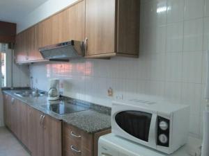 a kitchen with a microwave and a counter top at Apartment - 2 Bedrooms with WiFi and Sea views - 01893 in Bueu