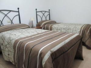 a room with three beds in a room at Apartment - 2 Bedrooms with WiFi and Sea views - 01893 in Bueu