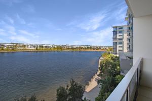 a view of a river from a building at Pool, 100m to Hosp, 3 TVs, 3 Beds - Lakefront Aquarius Apartment in Kawana Waters