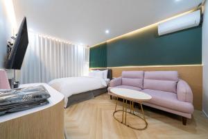 a hotel room with a bed and a couch at Browndot Hotel Namchuncheon in Chuncheon