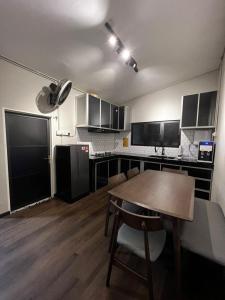 a kitchen with a wooden table in a room at BELLA COTTAGE in Pantai Cenang +8 photos