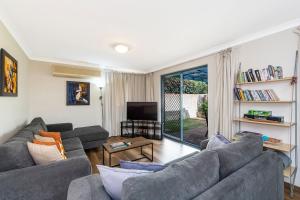 a living room with two couches and a tv at Bridges Retreat Dunsborough in Dunsborough
