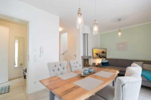 een woonkamer met een tafel en een bank bij Gartenhaus am Waldschloss App 1 in Heringsdorf