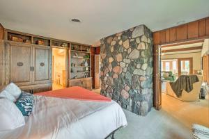 um quarto com uma parede de pedra e uma cama em Luxe Waterfront Haven Private Beach, Hot Tub em Benton Harbor