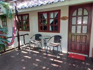 a patio with two chairs and a table in front of a house at Harley Moon Hideaway in Ko Chang