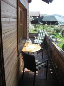 a patio with a table and chairs and an umbrella at Ferienwohnung Anneliese Eckhart in Anger