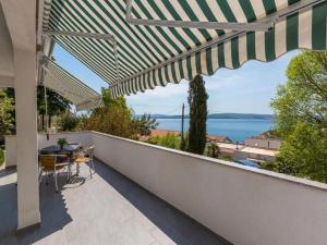 a balcony with a table and a view of the ocean at Apartments Jadranka in Dramalj