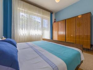 a bedroom with a large bed and a large window at Apartments Tara in Selce
