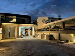 a large house with a driveway in front of it at 5000 SQFT BRAND NEW Semi-D Hype Home 10pax in Ipoh