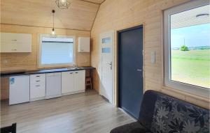 a kitchen in a tiny house with a large window at 2 Bedroom Pet Friendly Home In Jezierzany in Jezierzany