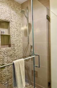 a shower with a glass door in a bathroom at Venice Beach Bungalow in Los Angeles