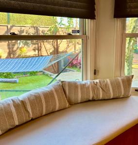 a window sill with a pillow in front of a window at Venice Beach Bungalow in Los Angeles
