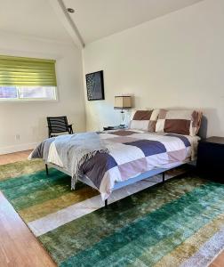 a bedroom with a large bed and a rug at Venice Beach Bungalow in Los Angeles