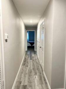 an empty hallway with a hallway leading to a room at Spacious/Cozy home in Fort Worth in Fort Worth