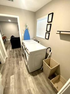a laundry room with a washing machine in it at Spacious/Cozy home in Fort Worth in Fort Worth