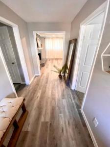 a hallway of a home with a couch and wooden floors at Spacious/Cozy home in Fort Worth in Fort Worth