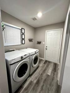 a laundry room with a washer and dryer in it at Spacious/Cozy home in Fort Worth in Fort Worth