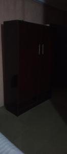a black cabinet with two doors in a room at Greendale apartment and Lodge in Ibadan