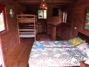 Un dormitorio con una cama y una escalera en una cabaña en B & Bee Wild Island - Nature Song en Fare
