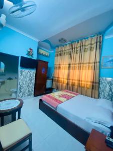 1 dormitorio con 1 cama, 1 mesa y 1 silla en Motel Hoa Hồng, en Vung Tau