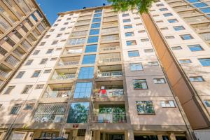 an apartment building with windows and balconies at Art-inspired 3BR Apartment in Nairobi