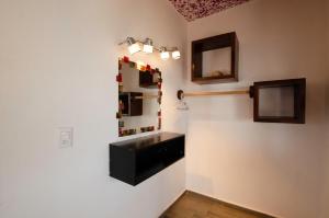 a bathroom with a sink and a mirror on the wall at Villas del Sol in Ipala