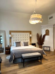 a bedroom with a large bed and a chandelier at Dome Hotel in Riga