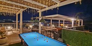 a pool table on a patio at night at Penthouse Bay View in Eilat