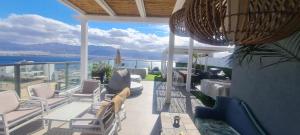 a balcony with chairs and a view of the ocean at Penthouse Bay View in Eilat