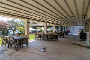 a dining room with tables and chairs and a large ceiling at Alesta Midtown in Fethiye