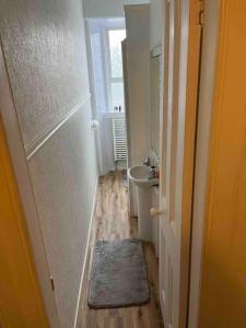 a small bathroom with a sink and a toilet at Centrally located 1 bed flat with furnishings & white goods. in Gourock