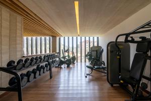 a gym with rows of tread machines in a room at Purple Haze By AirCasa in Nairobi