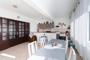 a kitchen with a table and chairs in a room at Rooms Mladen P in Banjol