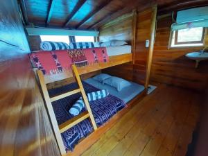 a room with two bunk beds in a cabin at Komodo Liveaboard 3 Days 2 Night in Labuan Bajo