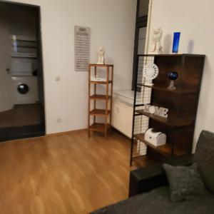 a living room with a wooden floor and a book shelf at Apartment Cozy B66 - Nähe Alexanderplatz in Berlin