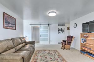 a living room with a couch and a chair at Pet-Friendly Aurora House with Mountain Views! in Salina