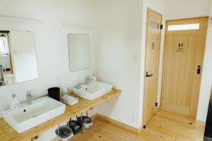 a bathroom with two sinks and a mirror at Worcation base Kaminyu Yamane House - Vacation STAY 03960v in Nagahama
