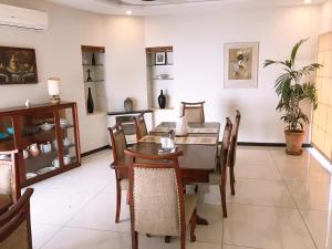 a dining room with a table and chairs at Morgah Resort - Guest Rooms in Rawalpindi