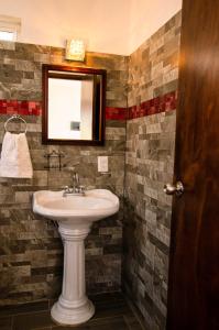 a bathroom with a sink and a mirror at Villas del Sol in Ipala +128 photos