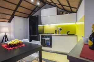 a kitchen with a table with a bowl of fruit on it at Villa Burica in Vinišće