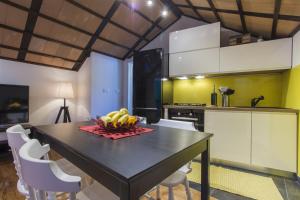 a kitchen with a table with a bowl of fruit on it at Villa Burica in Vinišće