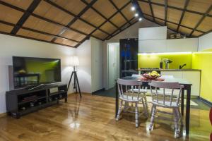 a kitchen and dining room with a table and chairs at Villa Burica in Vinišće