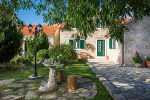 a house with a green door and a street light at Villa Giardino in Drniš