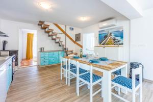 a kitchen and dining room with a table and chairs at Villa Turquoise breeze in Klenovica