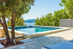 a swimming pool with a view of the water at Villa Turquoise breeze in Klenovica