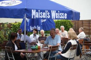 a group of people sitting at a table in a restaurant at Gasthof Stadt Brandenburg in Lutherstadt Wittenberg
