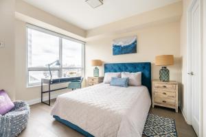 a bedroom with a bed and a desk and a window at GLOBALSTAY Modern Apartments in North York Skyscraper in Toronto