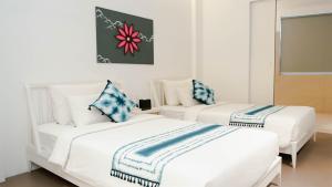 A bed or beds in a room at K Gallery Hotel