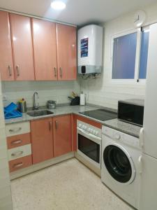 a kitchen with a sink and a washing machine at Motril - Poniente Beach in Motril